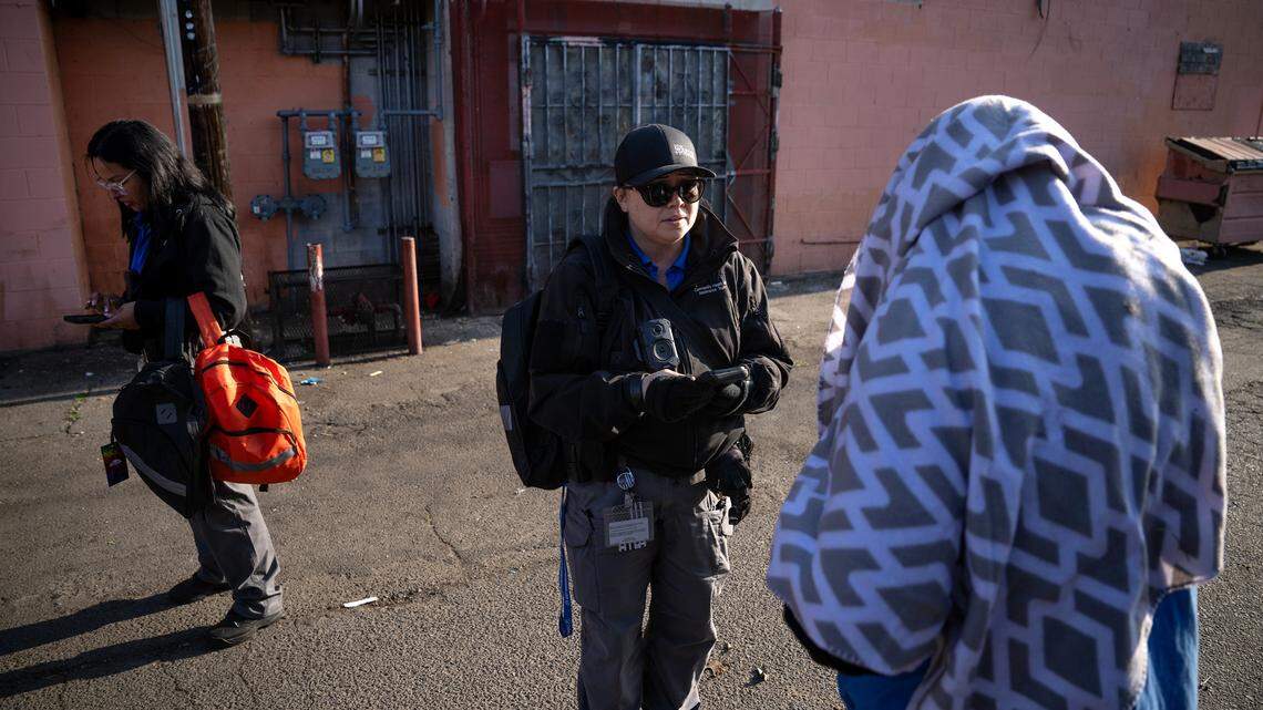 CHAT(Community Health and Assistance Team) outreach specialists Christina Kenney, right, and Christina Hernandez, left, talk with unhoused people during the county’s Point in Time homeless count in Modesto, Thursday, Jan. 30, 2025.