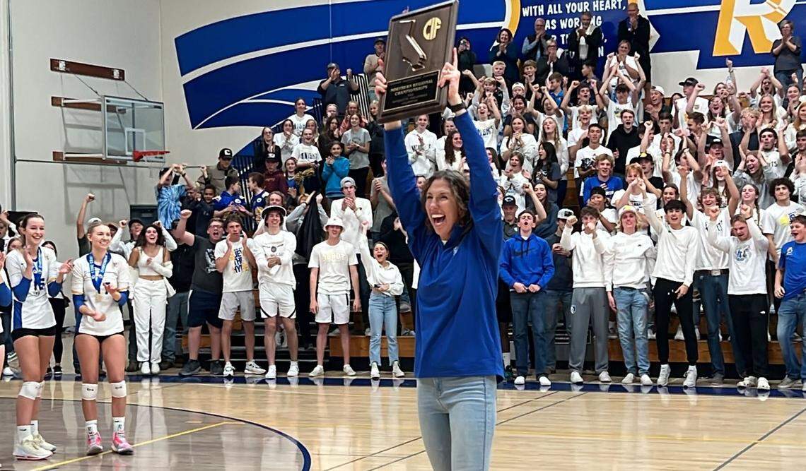 Ripon Christian coach Kayla Kootstra holds up the CIF Northern California Division IV champions plaque to the fans after the Knights’ 3-1 win over Head-Royce on Tuesday, Nov. 15, 2022.