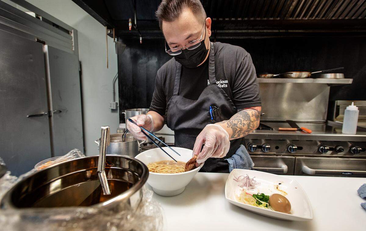 Owner and chef Ernie Watkins prepares a bowl of ramen at Konfucious Eats in McHenry Village in Modesto, Calif., on Thursday, Feb. 4, 2021.