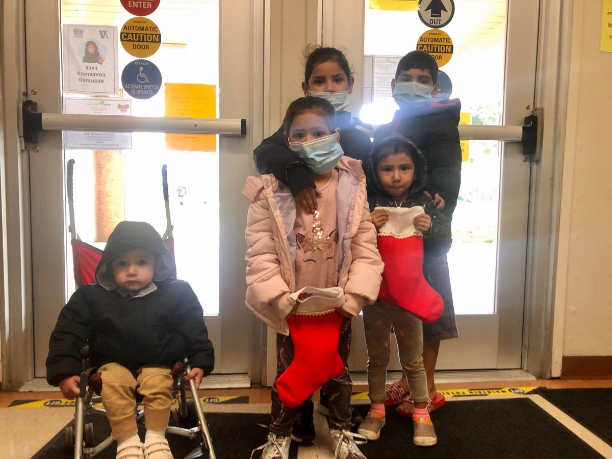 A Modesto family poses after receiving gifts at a local toy drive.