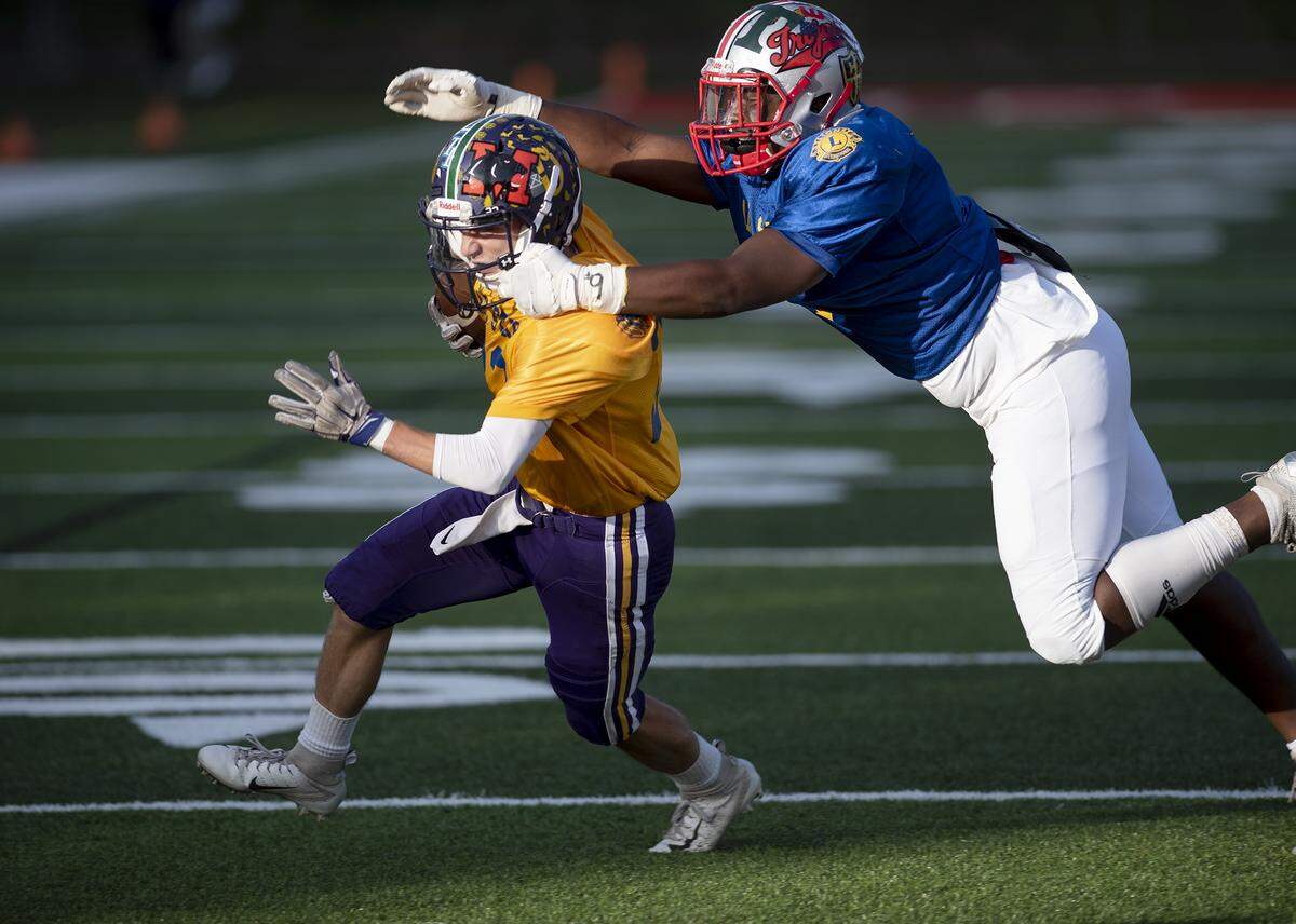 South receiver Tyler Vargas, (Orestimba) left, tries to elude North’s Jadhi West (Lincoln) during the Central California Lions All-Star Football game at Lincoln High School in Stockton, Calif., Saturday, June 15, 2019.