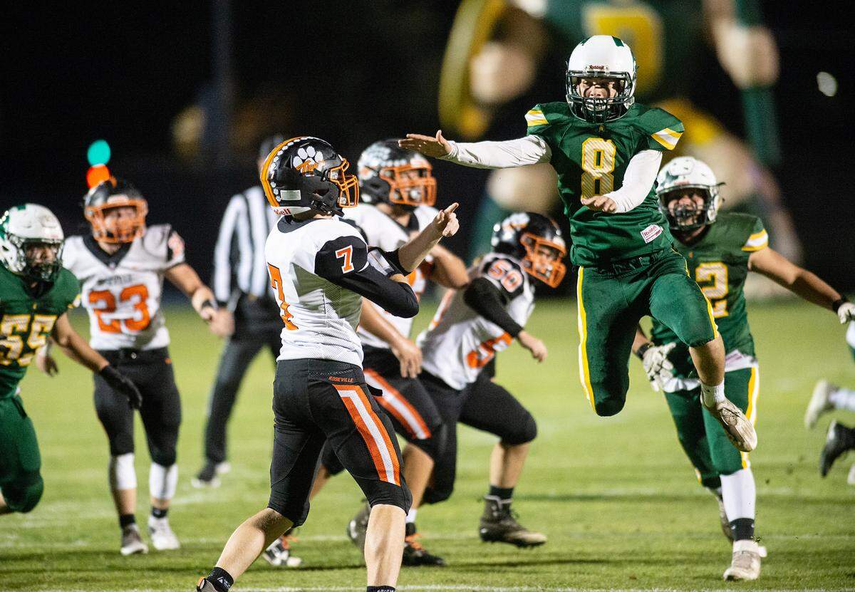 Davis’ Cobi Twist pressures Roseville quarterback Ryan Graydon in the Division III Sac-Joaquin Section football playoff game at Modesto Junior College, in Modesto Calif., on Friday, Nov. 5, 2021. Roseville won the game 33-21.