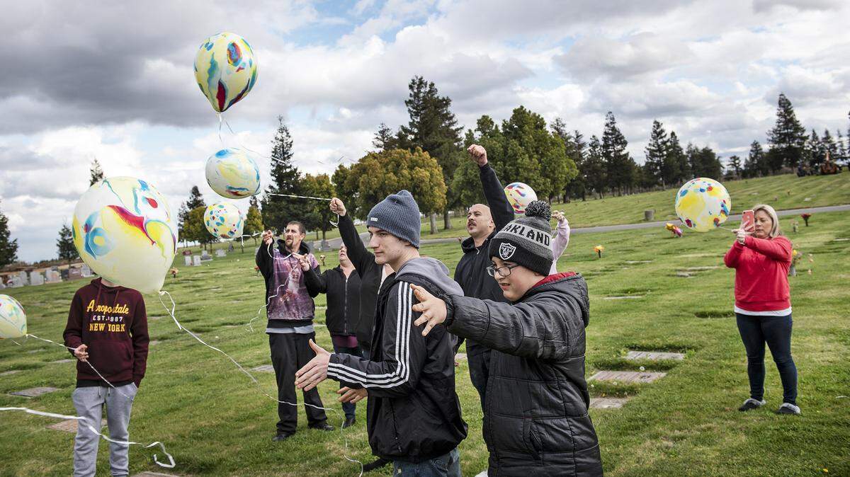 Mark McRorie’s two sons Marcus McRorie Jr., 16, middle, and Jordan McRorie, 11, right, and other family members release balloons to remember Mark at Lakewood Memorial Park in Hughson, Calif., on Saturday, March. 7, 2020. Every year on the anniversary of his death, McRorie’s sons and family release balloons in his memory.