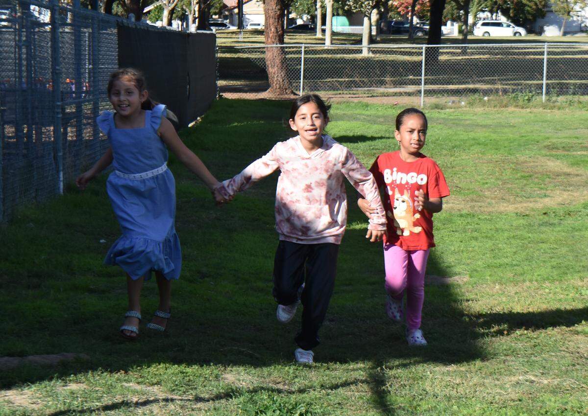 Students at Modesto’s Robertson Road Elementary School do their regular Friday afternoon 1-mile run around a school field. Photographed Nov. 7, 2025.