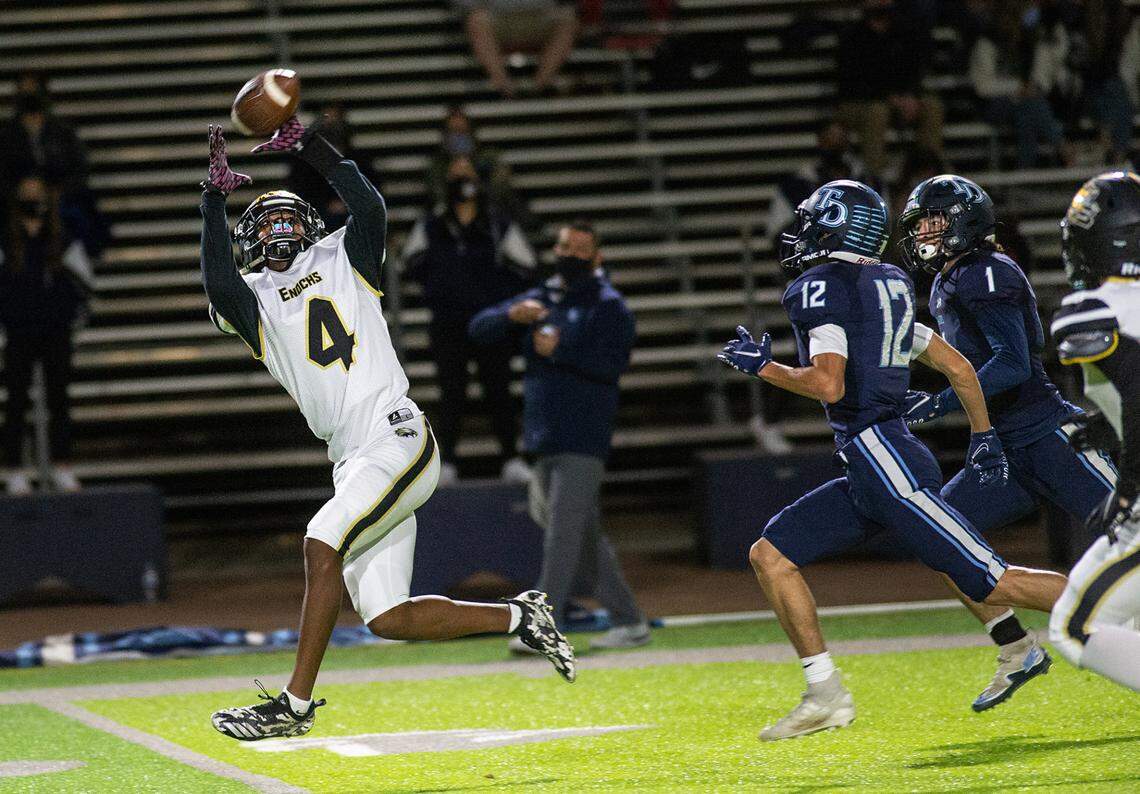 Enochs’ Kola Babalola intercepts a pass during the Central California Athletic League game with Downey at Downey High School in Modesto, Calif., on Friday, March 26, 2021.