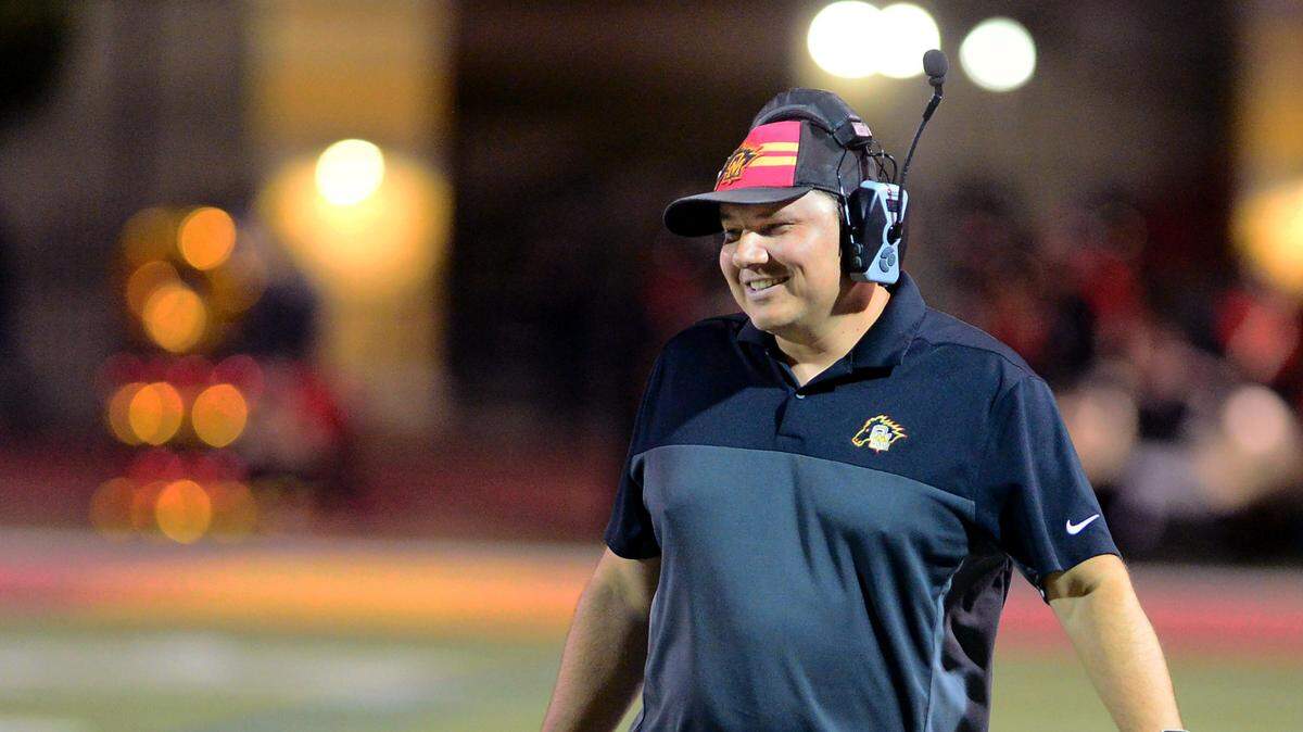 Oakdale Head Coach Garrett Martin smiles during a game between Oakdale High School and Patterson High School at Oakdale High School in Oakdale California on October 11, 2024. Oakdale won the game 56-40.