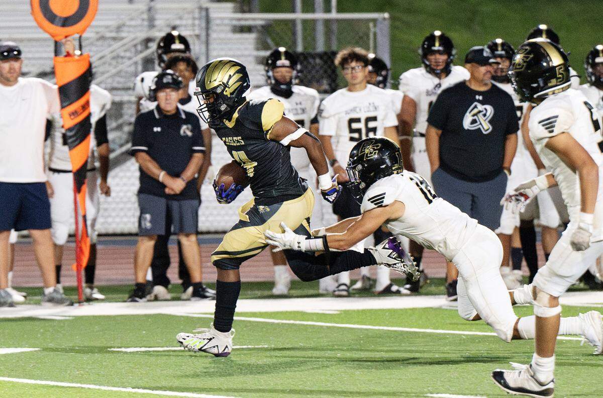 Enochs’ Aiden Muhammad breaks tackles and runs for a touchdown during the non-league game with Buhach Colony at Gregori High School in Modesto, Calif., Friday, Sept. 1, 2023. Muhammad rushed for five touchdowns in the Eagles 54-8 victory.