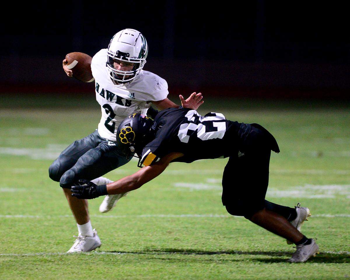 Central Valley quarterback Mario Gonzalez gets hit by a Hughson defender during a game between Hughson High School and Central Valley High School at Hughson High School in Hughson California on August 25, 2023.