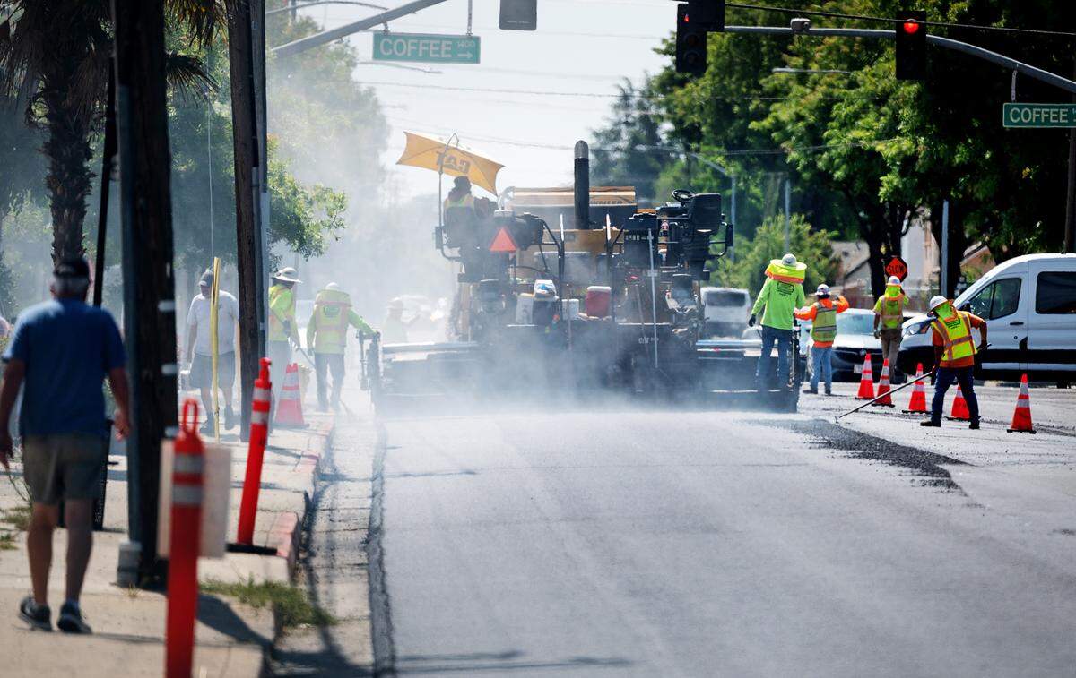 A crew from United Pavement Maintenance Inc. resurfaces Orangeburg Avenue from Coffee Road to Oakdale Road in Modesto, Calif., Thursday, June 22, 2023.
