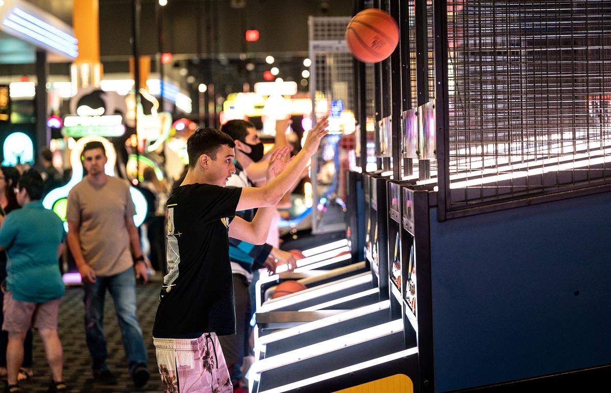 Nick Sturgill shoots baskets Dave & Buster’s entertainment center and restaurant at Vintage Faire Mall in Modesto, Calif., on Thursday, June 2, 2022.