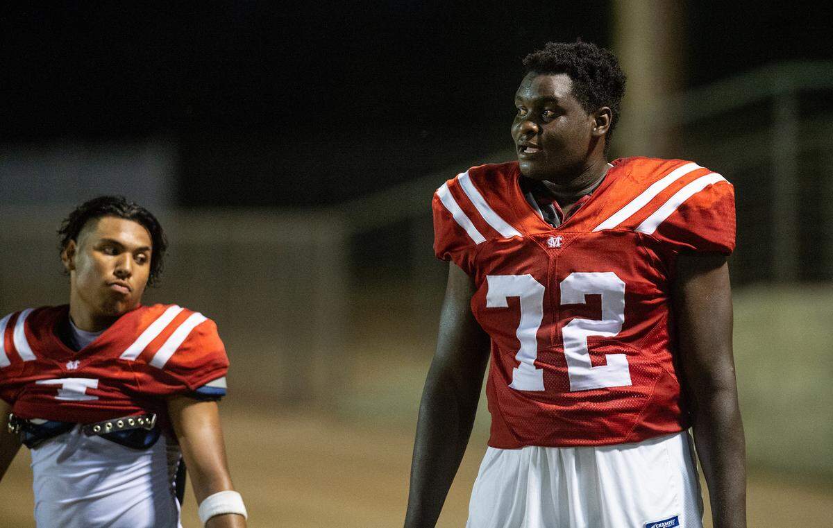 Modesto Christian’s Manasse Itete, right, watches the action from the sideline with teammate Raymond Corral Jr., left, during the non-league game with Delta Charter at Modesto Christian High School in Salida, Calif., on Friday, September 9, 2022.