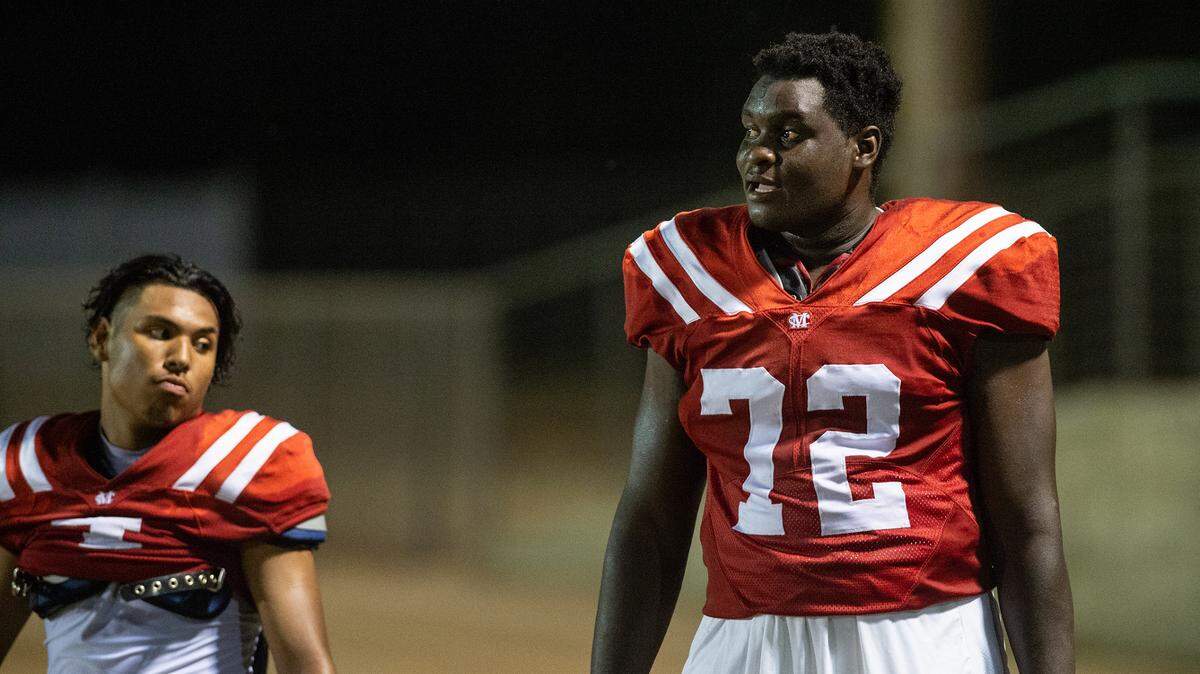 Modesto Christian’s Manasse Itete, right, watches the action from the sideline with teammate Raymond Corral Jr., left, during the non-league game with Delta Charter at Modesto Christian High School in Salida, Calif., on Friday, September 9, 2022.