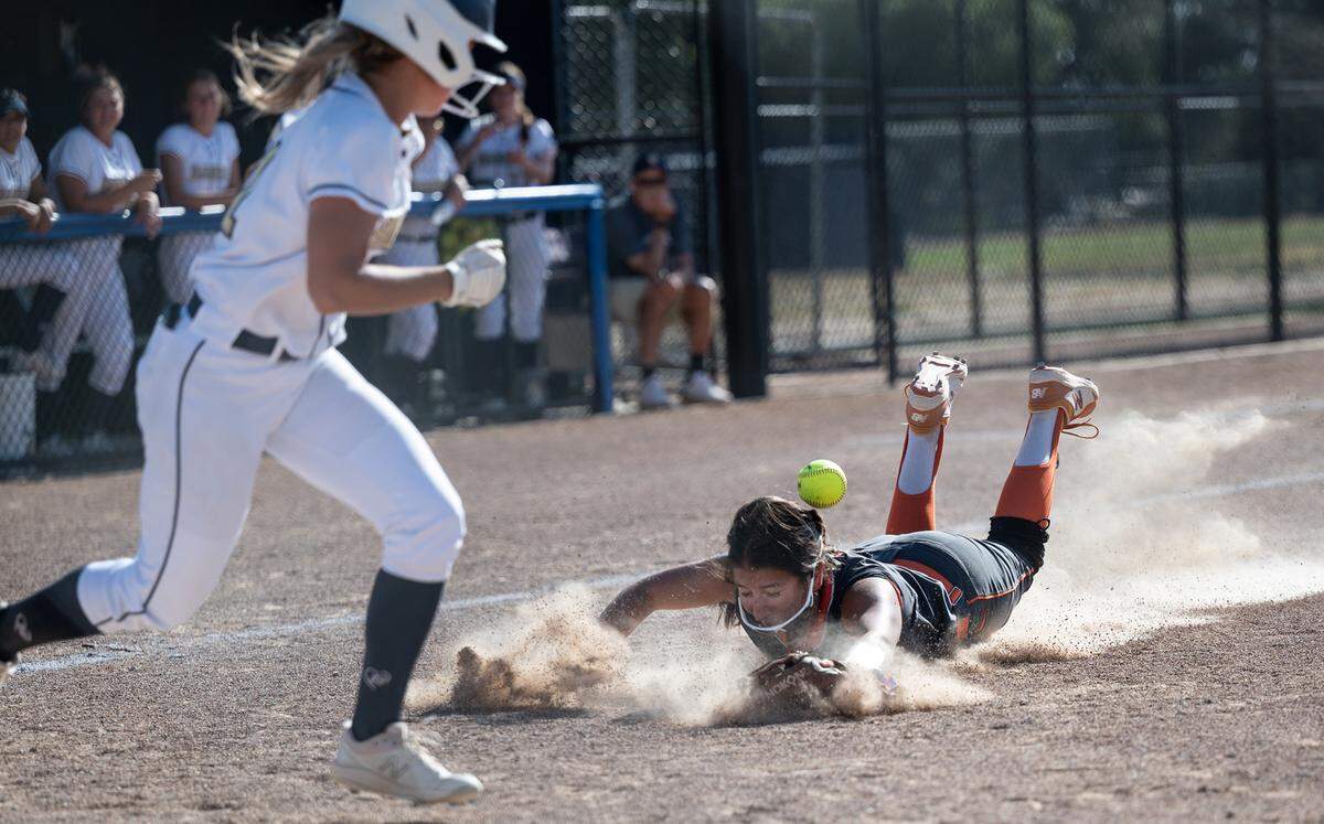 Merced third baseman Madelyn Mayo-Garza dives for a pop-up bunt from Central Catholic’s Adison Machado during the CIF Sac-Joaquin Section Division III softball playoffs at Central Catholic High School in Modesto, Calif., on Thursday, May 19, 2022. Central Catholic won the game 4-1.