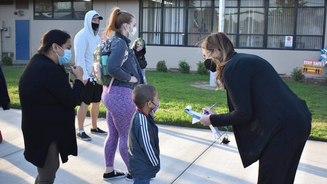 Principal Jenny Henderson welcomes children to Julien School in the Turlock Unified School District on Monday morning, Oct. 26, 2020. It was the first day of in-person instruction for transitional kindergartners and kindergartners.