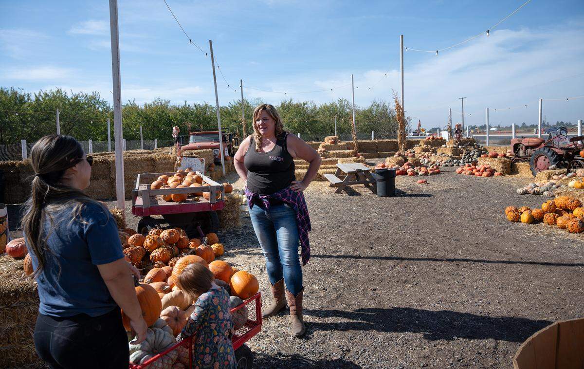 Owner Antoinette Rodin, right, talks with Becky Schott at Rodin Farms Fruit Stand near Modesto, Calif., Wednesday, Nov. 1, 2023. The 30-year-old fruit stand is in the path of the North County Corridor Expressway project and will need to be relocated or reconfigured.