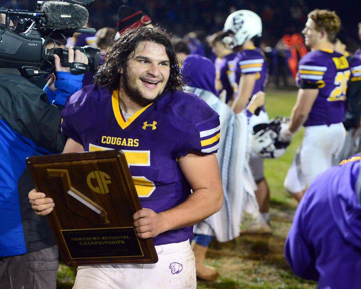 Escalon’s Tate Christensen celebrates the win with the NorCal Bowl Game plaque after the 2022 CIF Nor Cal Division 4-AA Bowl Game between Escalon High School and Pleasant Valley High School at Escalon High School in Escalon CA on Dec. 2, 2022. Escalon won the game 42-20.