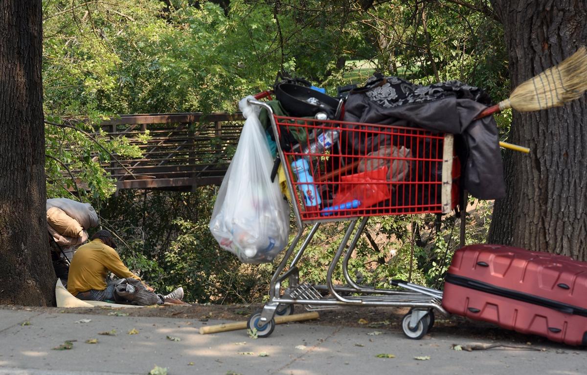 A homeless person sits in Moose Park Monday afternoon August 6, 2018 near the corner of Rue De Yoe and N Morton Blvd. in Modesto, Calif. There has been reaction from La Loma residents that the county proposed homeless shelter will increase transient presence in their neighborhood. 