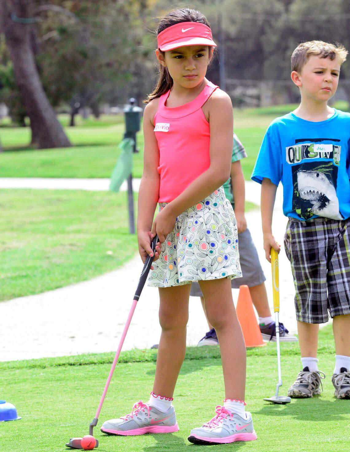 Oliva Gutierrez eyes the first hole of putting during the First Tee Central Valley youth golf program at the Modesto Municipal Golf Course in 2014.