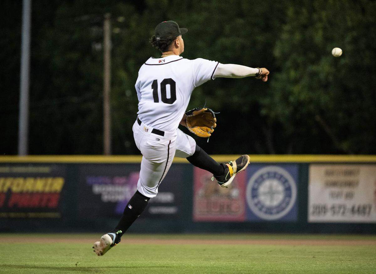 Modesto Nuts third baseman Luis Suisbel throws out a Stockton runner at John Thurman Field in Modesto, Calif., Friday, July 19, 2024.