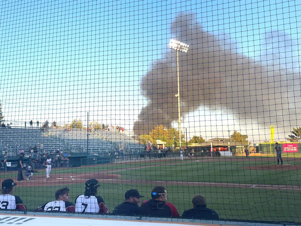 A wood pallet fire that caused an estimated $1.2 million in damages could be seen from John Thurman Field during the Modesto Nuts game against the Visalia Rawhide on Friday, Aug. 09, 2024.