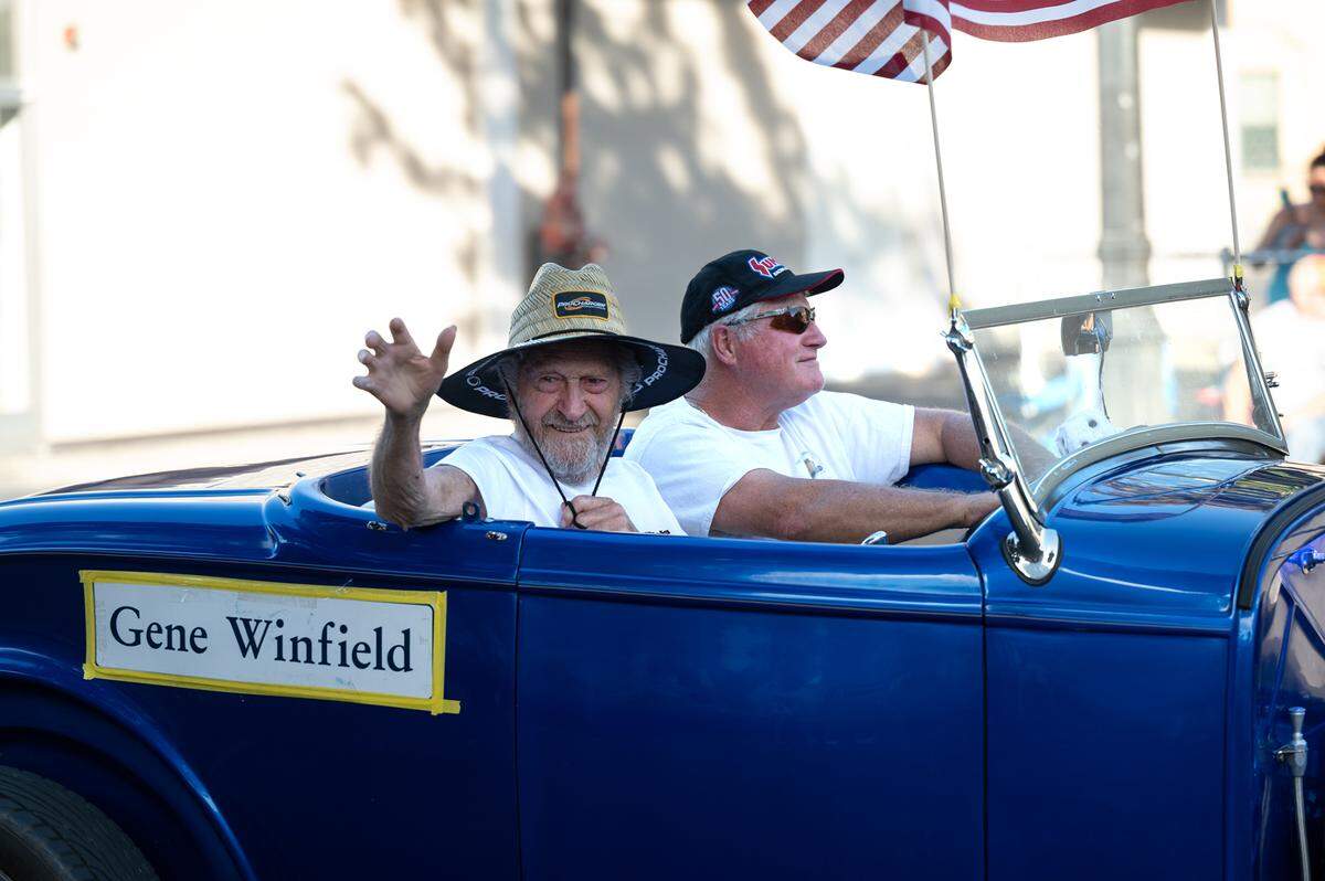 Famed car customizer Gene Winfield waves to the crowd during the “American Graffiti” car parade in Modesto, Calif., on Friday, June 10, 2022.