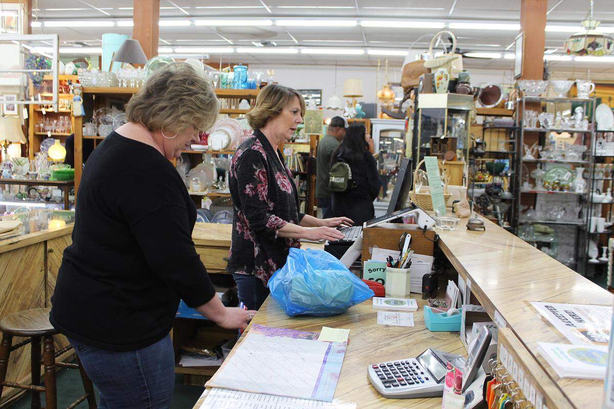 Main Street Antiques co-owners Jennifer Jensen, left, and Lori Smith, right, work at their store in Turlock, Calif., on Tuesday, April 19, 2022. Smith said downtown Turlock businesses have been resilient during the COVID-19 pandemic.