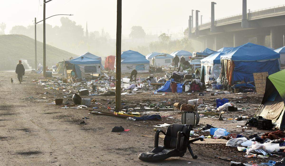 Belongings of people who’ve already left are strewn about on Wednesday, Dec. 11, 2019, the closing day of the Modesto Outdoor Emergency Shelter next to and beneath the Ninth Street bridge.
