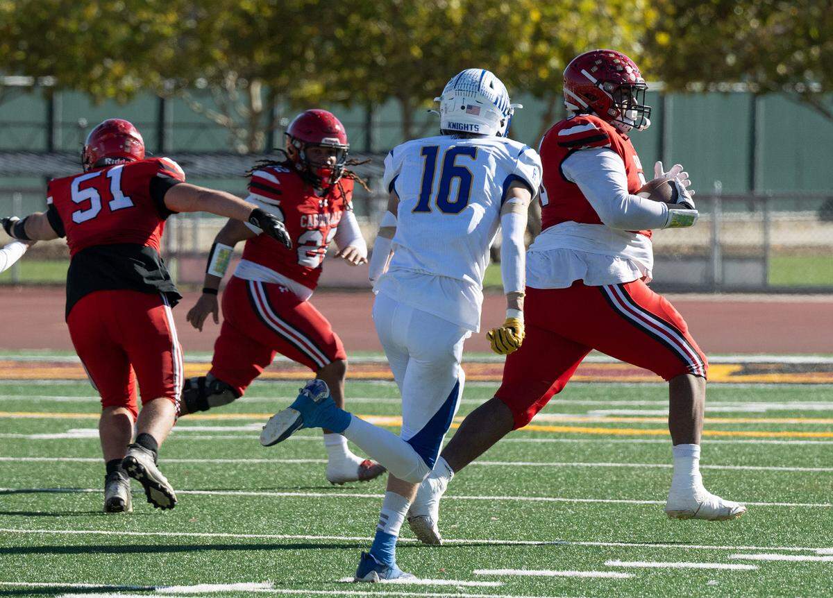 Woodland Christian’ Noah Rico, right, runs the ball after an interception during the Sac-Joaquin Section Division VII NorCal Qualifier with Ripon Christian at Sacramento City College in Sacramento, Calif., Saturday, Nov. 25, 2023.