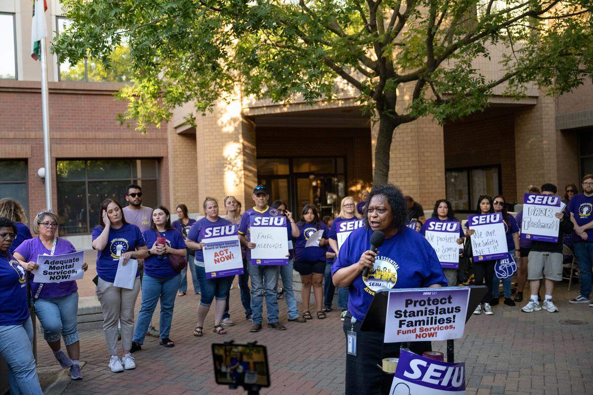 Service Employees International Union Local 521 member Karyn Clark speaks during a press conference before a Stanislaus County supervisors meeting at 10th Street Place in Modesto, Tuesday, Sept. 16, 2025. The union is representing frontline workers in BHRS, child welfare services, Child Protective Services and health programs in contract negotiations that began in March.