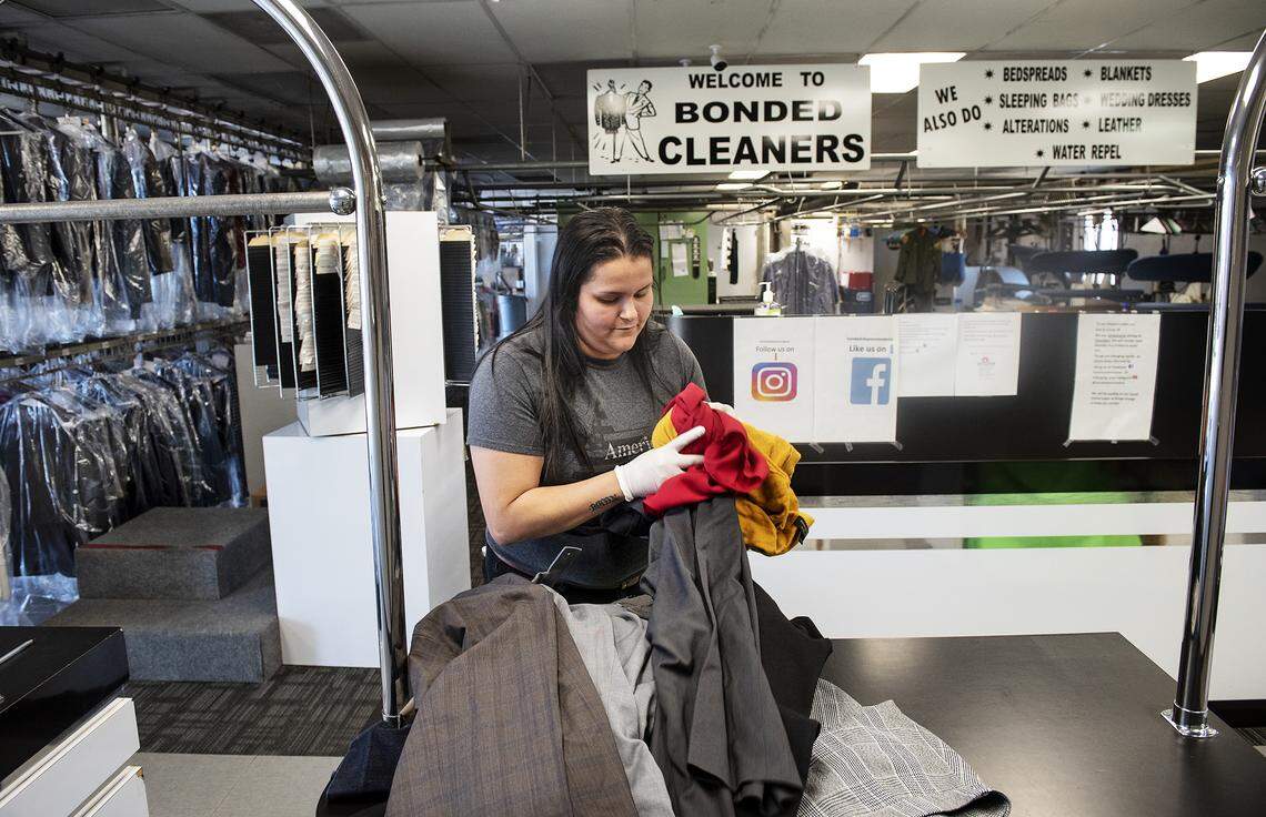 Cynthia Bastardo checks in clothing at Bonded Cleaners in Modesto, Calif., on Thursday, April 2, 2020.