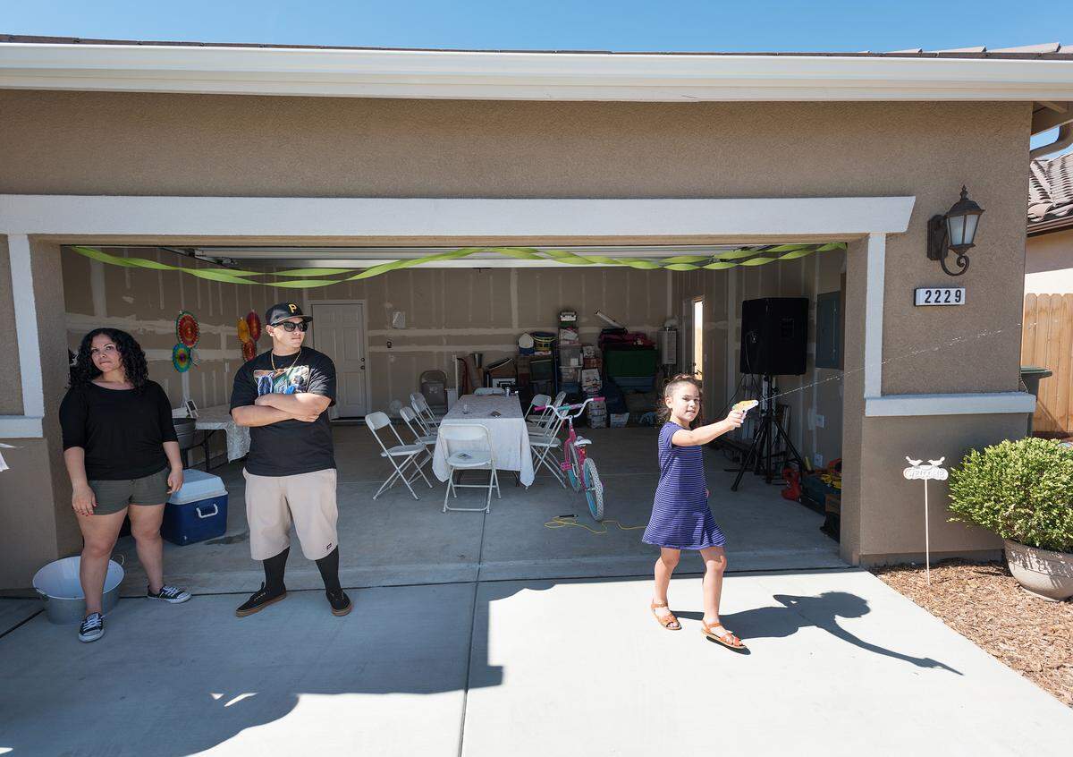 Home owner Tanya Vega, left, recently moved into the Cypress Grove a Century Communities development in east Modesto, Calif., Saturday, June 16, 2018. 