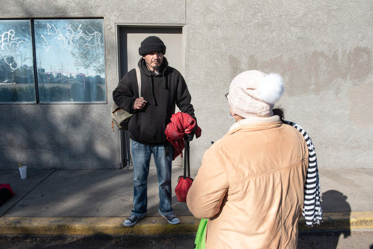 Arturo, left, talks with volunteer Hilda Vega during the annual count of Stanislaus County’s homeless in Modesto, Calif., on Thursday, Feb. 24, 2022. The U.S. Department of Housing and Urban Development requires local communities to conduct the annual point-in-time count to receive homeless funding.