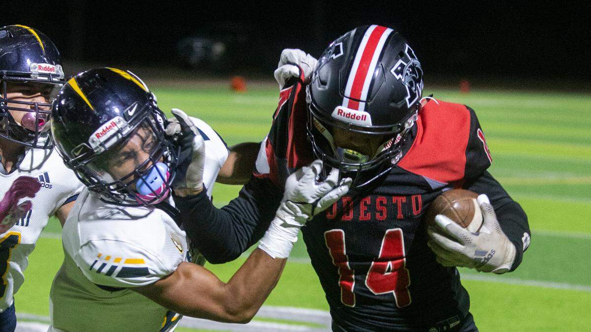 Julian Gonzalez, 14, of Modesto battles with a Gregori defender during Thursday nights game. Modesto took on Gregori football at Downey Thursday, Oct. 07, 2021 in a battle that left Modesto with another loss of 15-43.