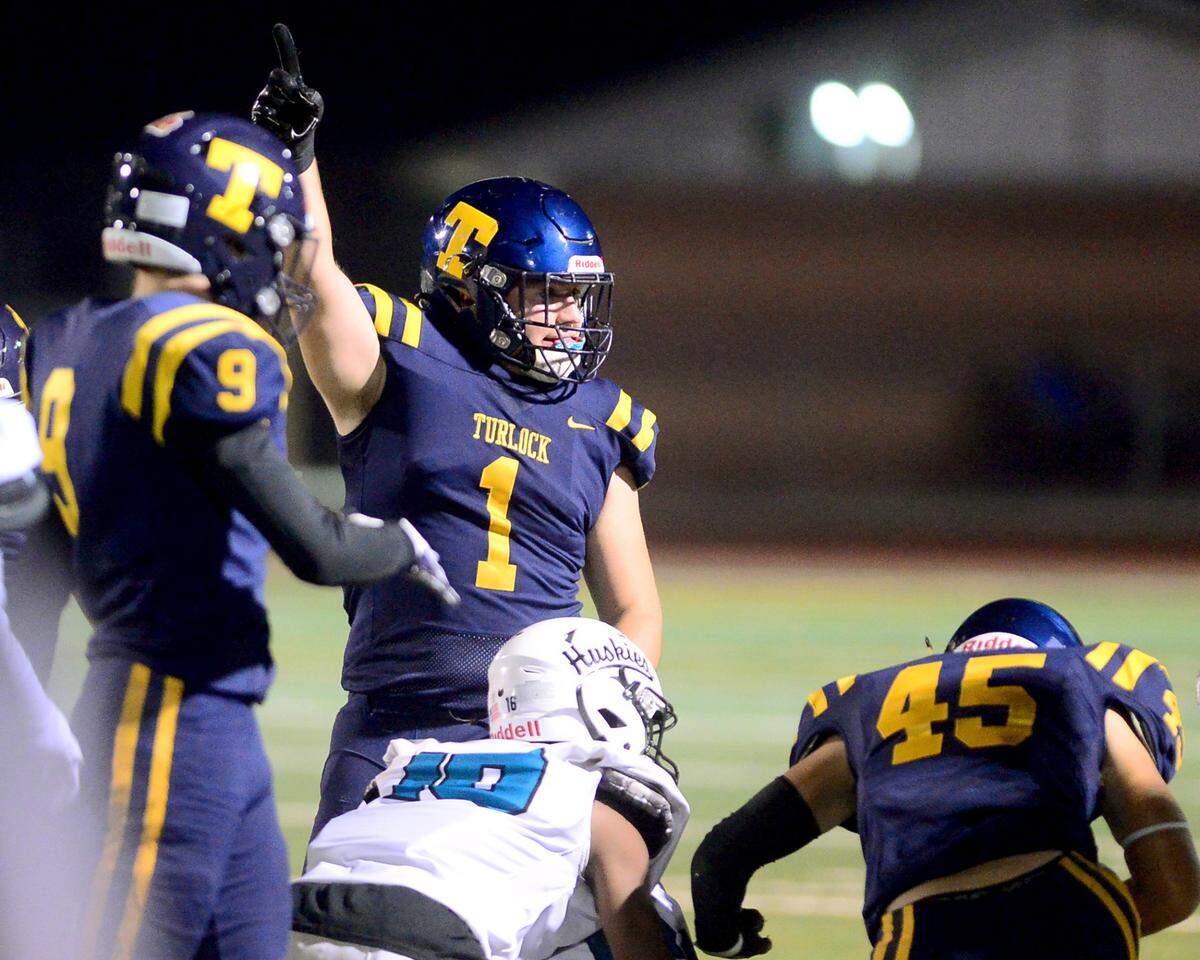 Turlock defensive end Owen Miller (1) celebrates a fumble recovery during a CIF Sac-Joaquin Section Football Division I playoff game between Turlock High School and Sheldon High School at Turlock High School in Turlock, California on Nov. 3, 2023.
