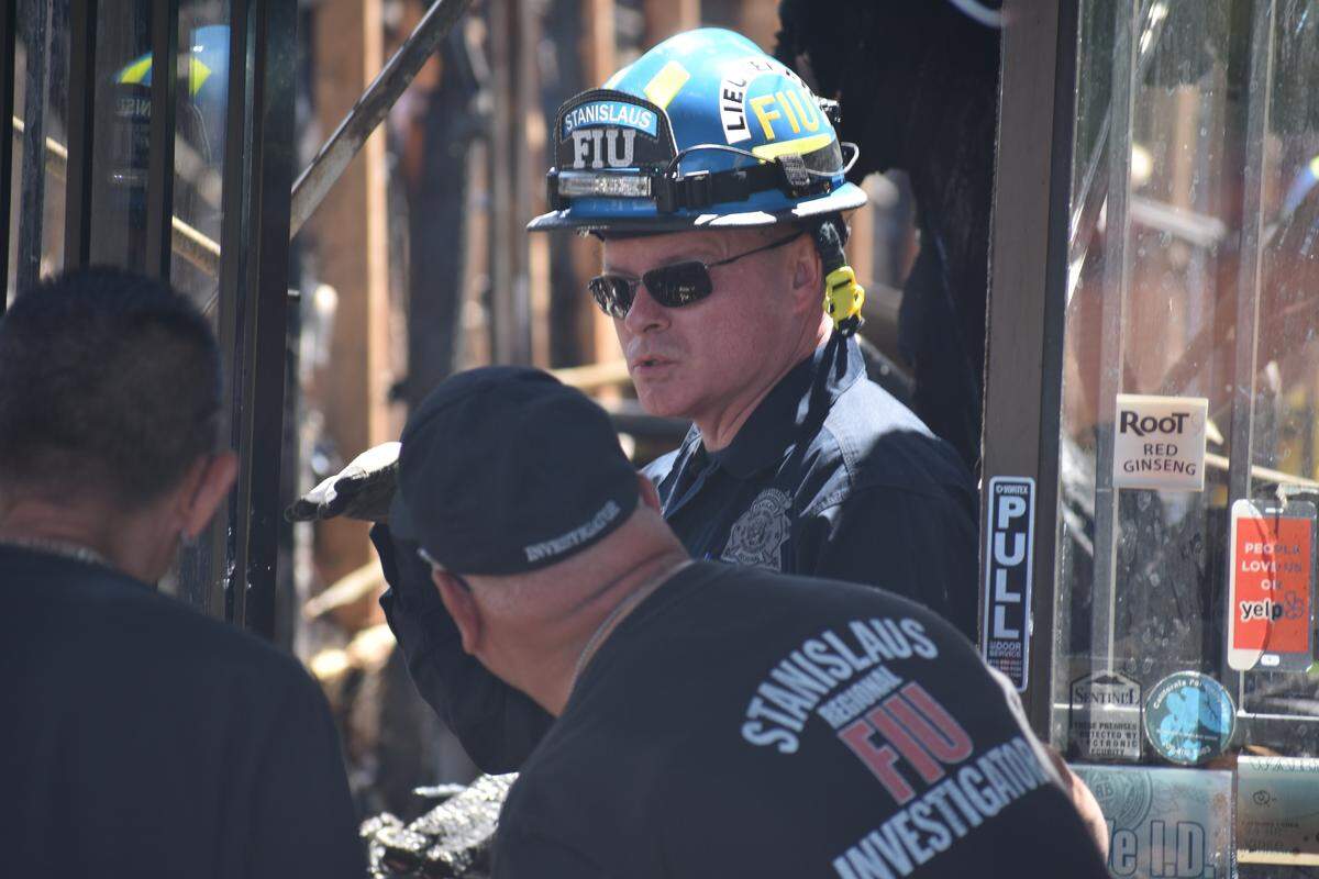 Lt. Dave Hutchinson and other members of the Stanislaus Regional Fire Investigation Unit on Saturday June 8, 2019, search the burned remains of the Asian Market after a fire destroyed it and four other businesses at the shopping center on Carver Road in Modesto, California.
