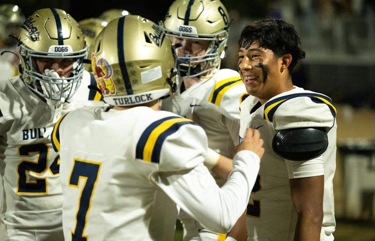 Turlock’s Alex Ventura, right, talks with teammates after a touchdown run during the Sac-Joaquin Section Division I playoff game with Central Catholic at Central Catholic High School in Modesto, Friday, Nov. 15, 2024.