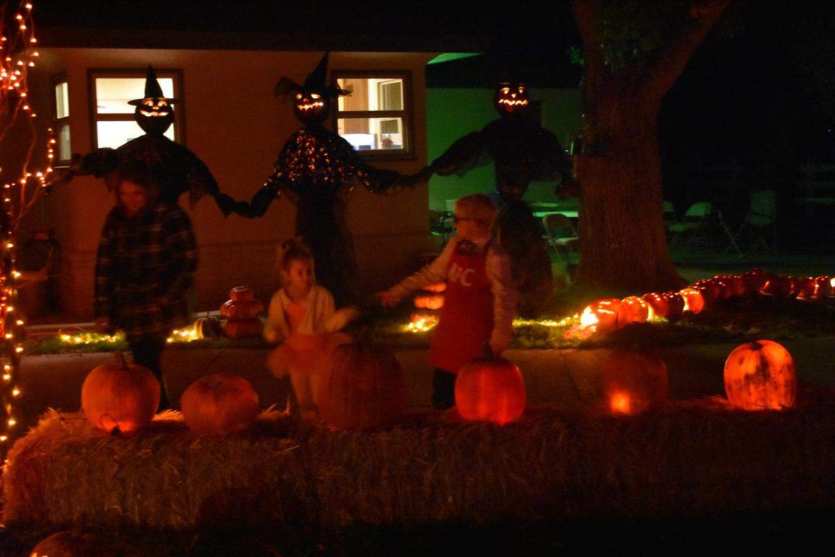 Friendly witches watch over visitors to a walk-through display at the Munns home at 7667 Rodden Road, Oakdale, on Halloween night, Oct. 31, 2019.