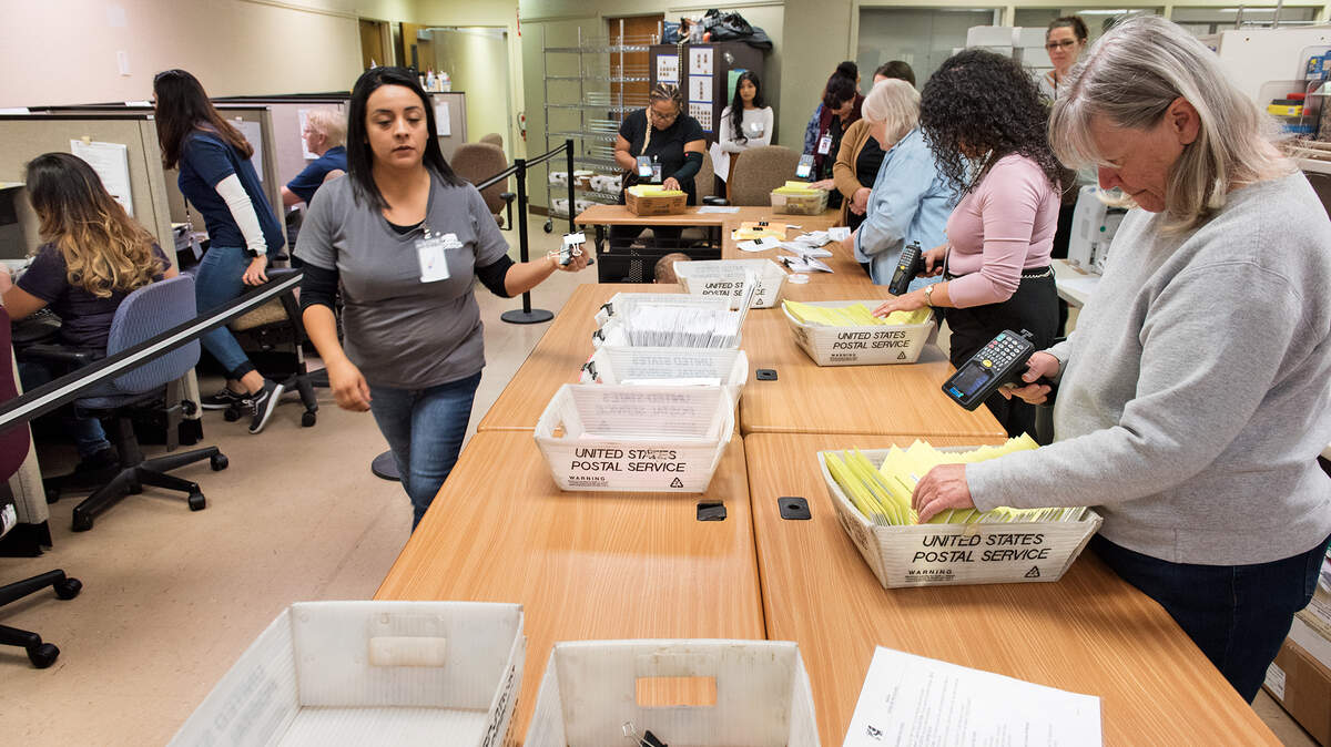 Workers scan ballots prior to counting at the Stanislaus County Clerk Recorders office  in Modesto, Calif., Wednesday, Nov. 7, 2018. 