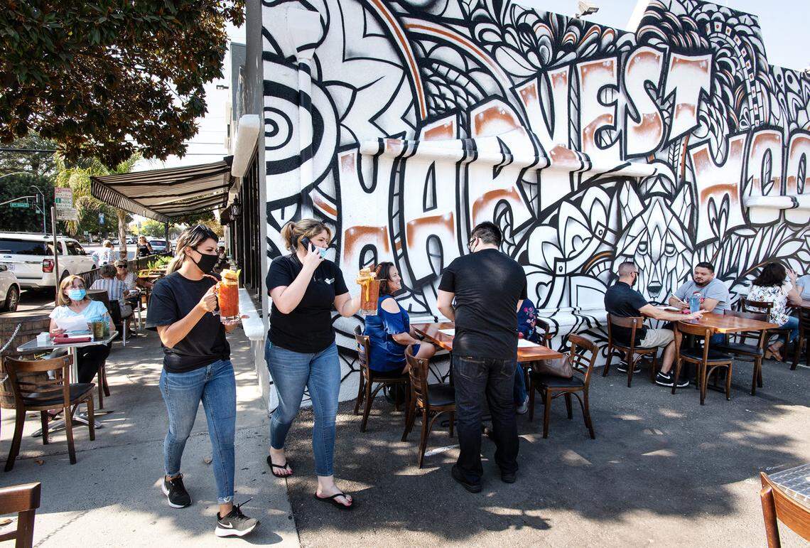 Harvest Moon restaurant owners Marilyn Prescott and Jessie Wiggins, left, reopened this week in Modesto, Calif., on Friday, Oct. 16, 2020.