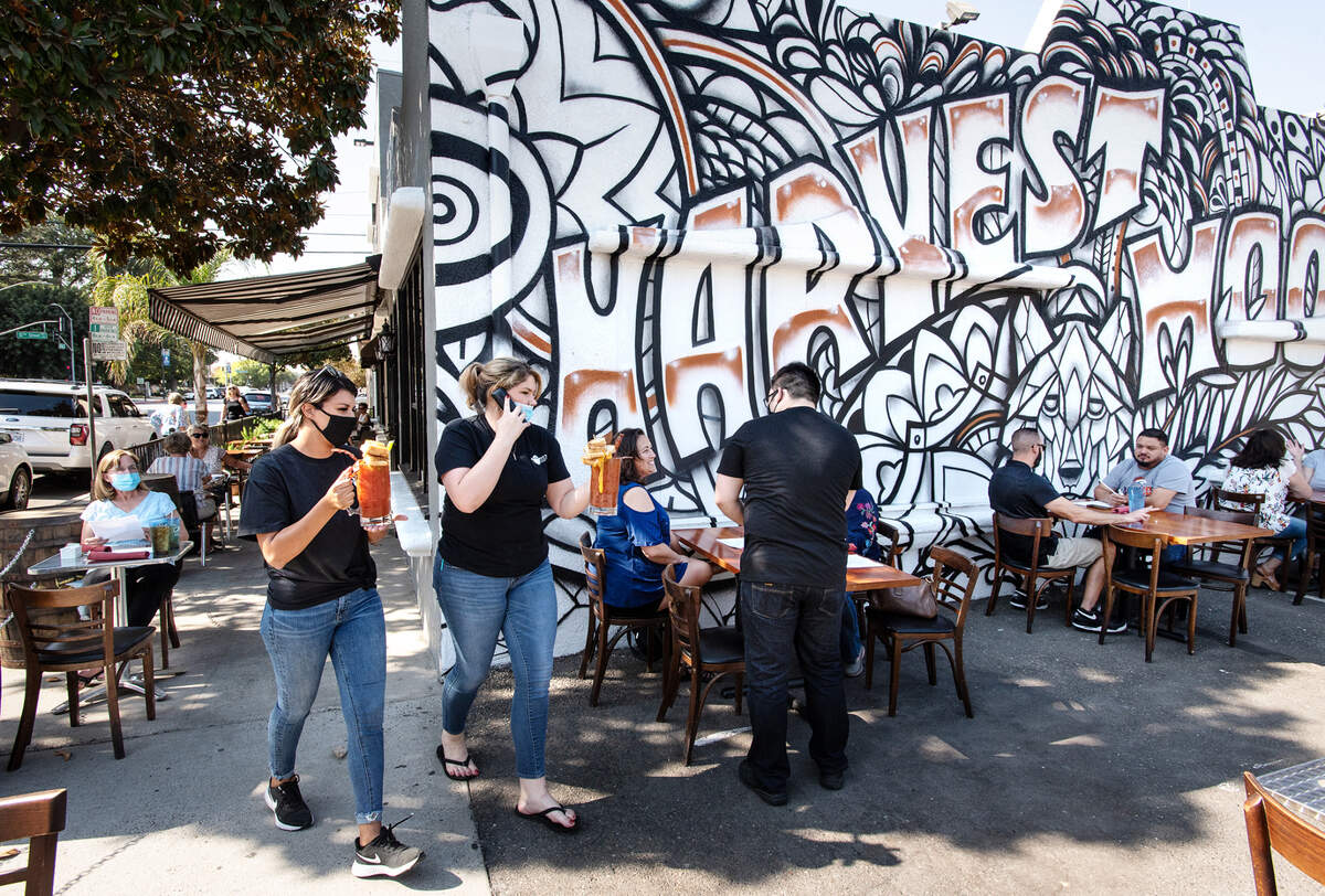 Harvest Moon restaurant owners Marilyn Prescott and Jessie Wiggins, left, reopened this week in Modesto, Calif., on Friday, Oct. 16, 2020.