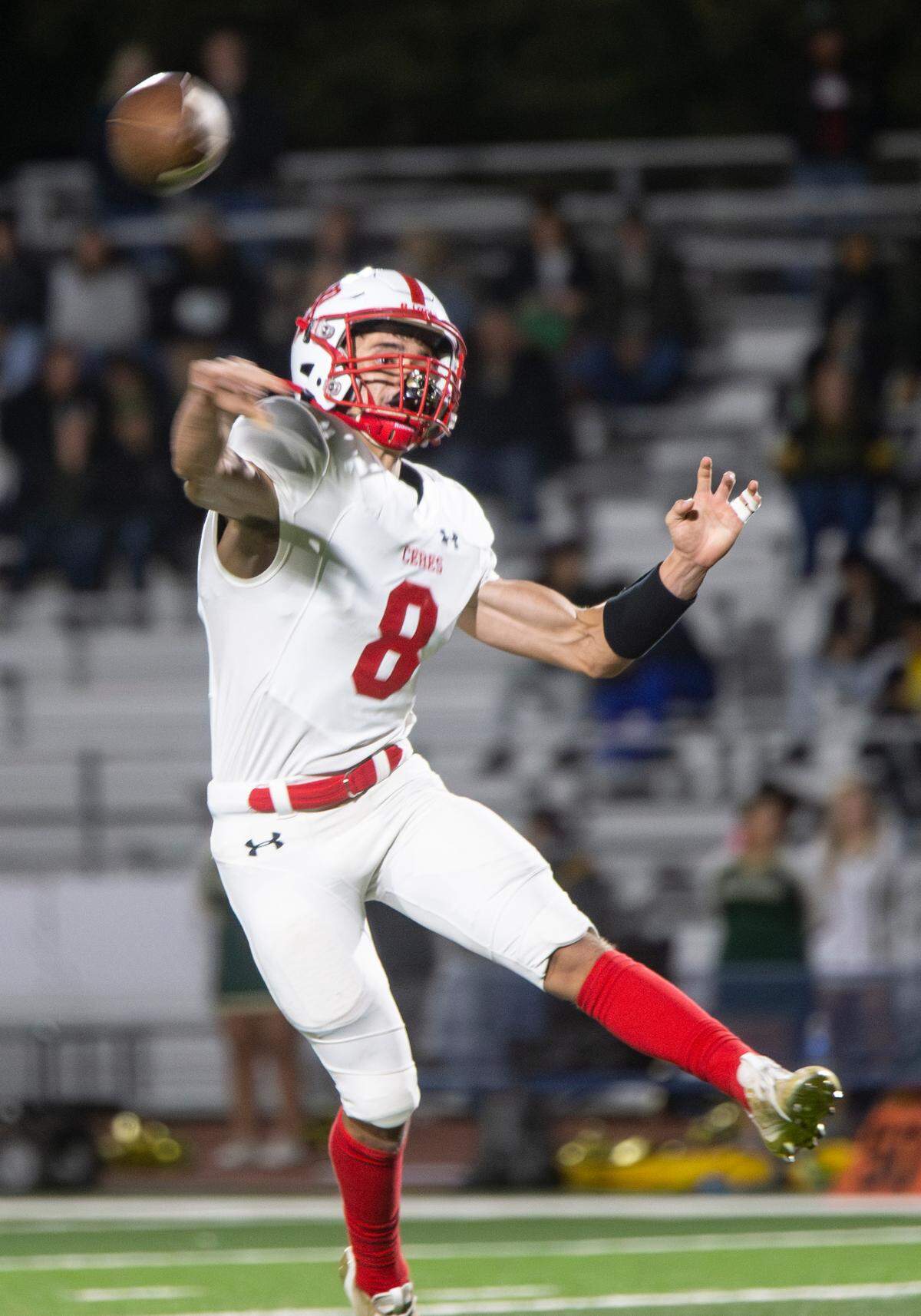 Donovan Osuna, 8, of Ceres High throws a first-down pass during the first half of a WAC game against Davis High on Friday Oct. 27, 2023.
