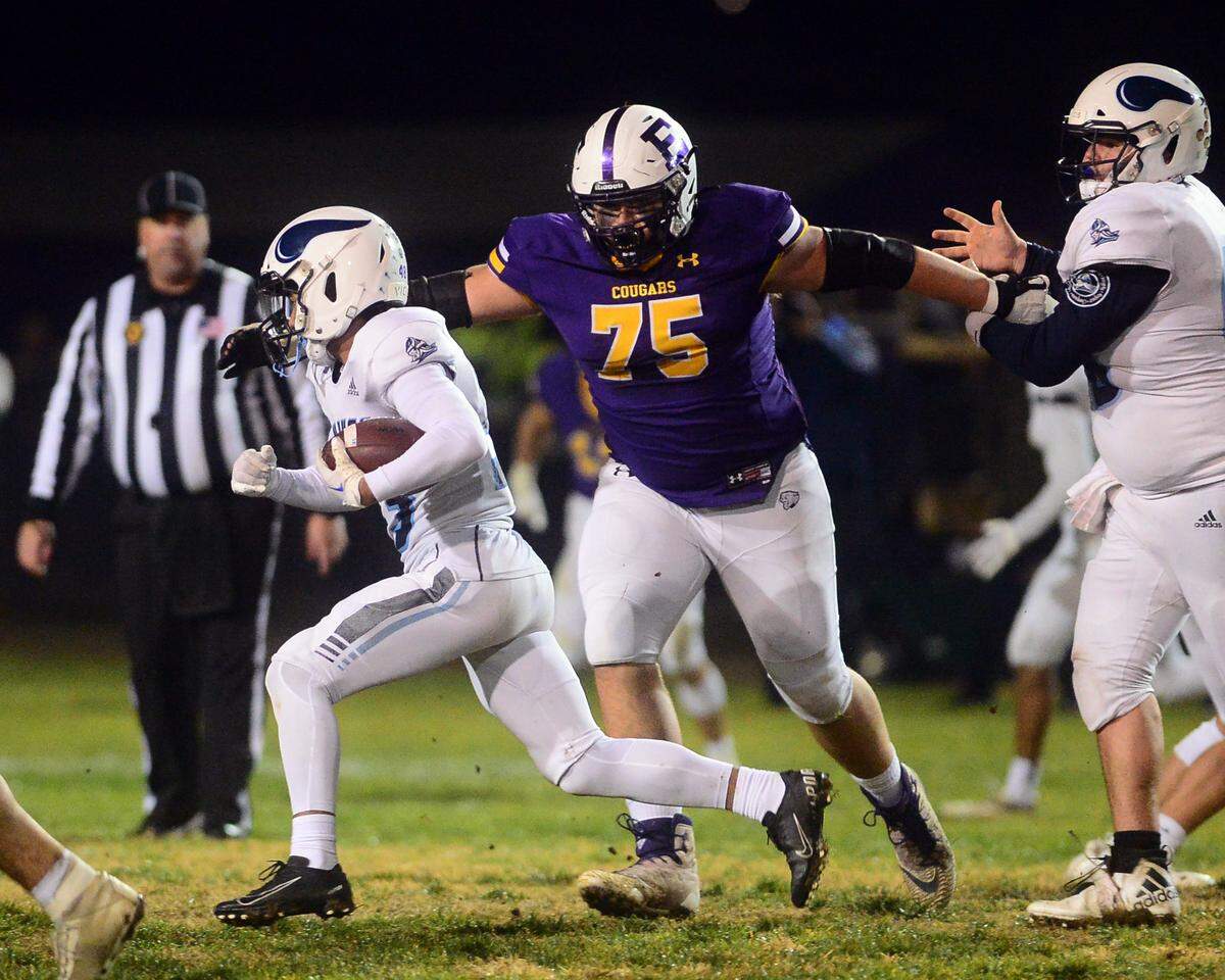 Escalon defensive tackle Jacob Rauch (75) closes in on Pleasant Valley running back Matthew Kinoshita during the 2022 CIF NorCal Division 4-AA Bowl Game between Escalon High School and Pleasant Valley High School at Escalon High School in Escalon CA on Dec. 2, 2022. Escalon won the game 42-20.