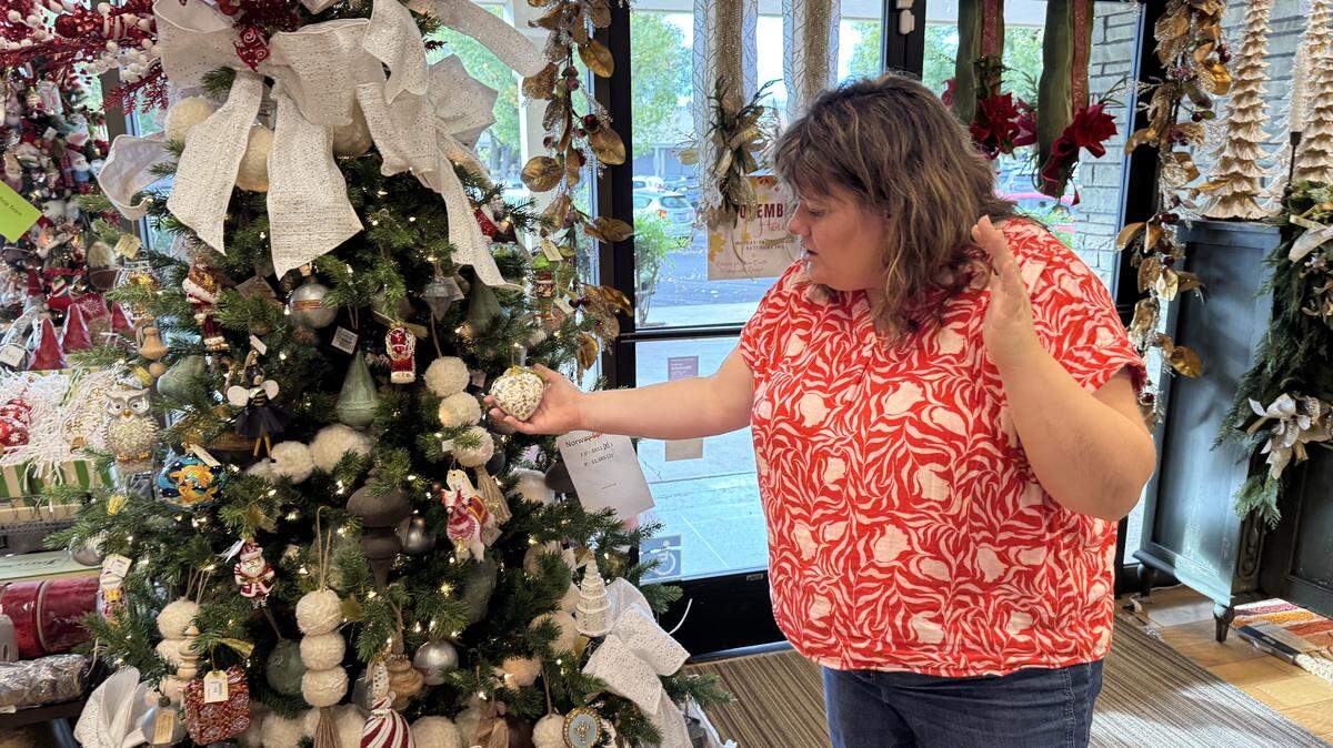 Store owner and manager Emma Grover talks about heirloom Christmas ornaments at Suite 52 Living in McHenry Village in Modesto.