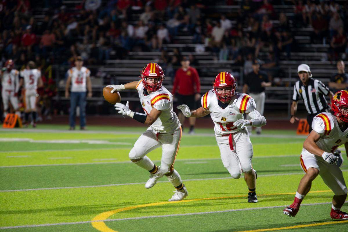 Chase Lopez, 6 of Oakdale High looks up field with teammate Wes Burford, 12, protecting him during the Oakdale vs Enochs game Friday Sept. 22, 2023