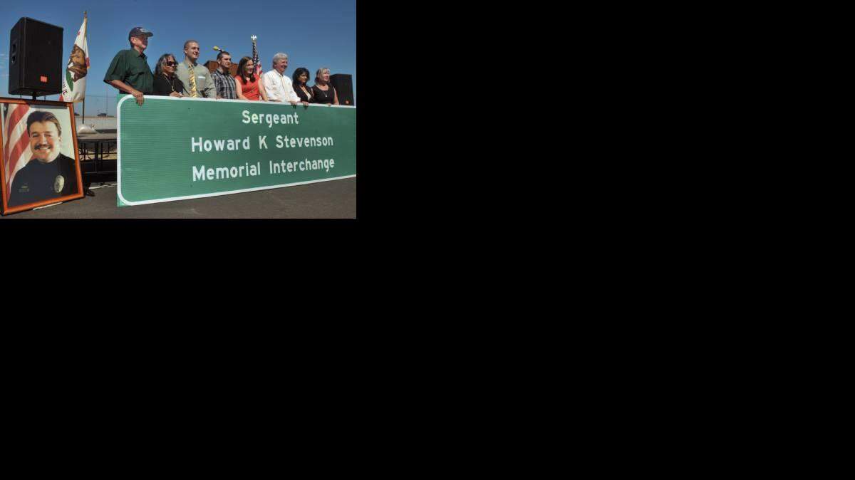 DEBBIE NODA/dnoda@modbee.com - Family members and Assemblyman Bill Berryhill, third from right, pose for photos by the sign after the Sergeant Howard K. Stevenson Memorial Interchange Dedication, September 23, 2011 in Ceres adjacent to the site.