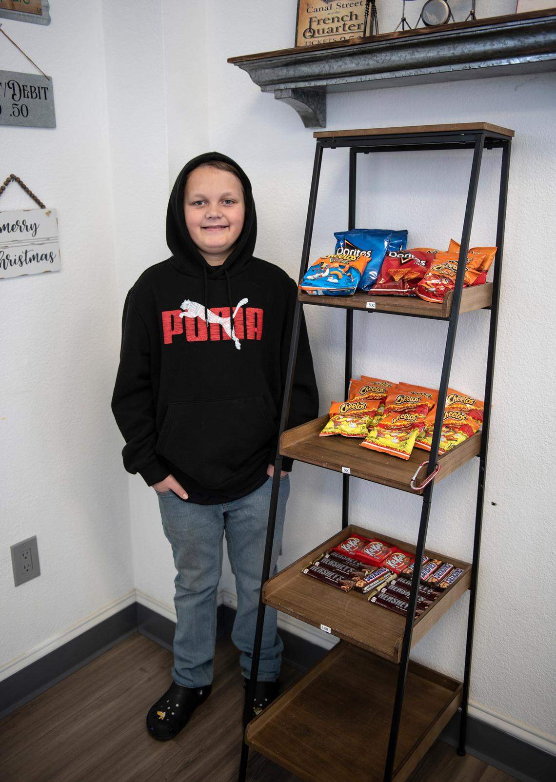 Dylan McDonald at his family shave-ice shop in Oakdale, Calif., on Monday, Dec. 27, 2021. He uses the money he makes from tips to buy candy in bulk and sell it for a profit, he said.