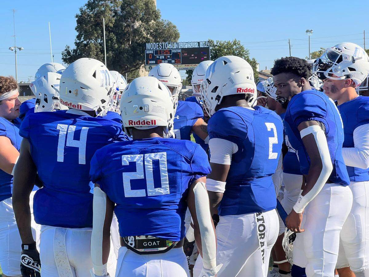 Modesto Junior College defensive backs meet on the sideline in the first half of their season opener against Laney College. The Eagles came back to win 26-25