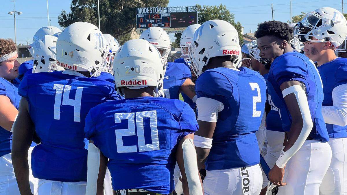 Modesto Junior College defensive backs meet on the sideline in the first half of their season opener against Laney College. The Eagles came back to win 26-25.
