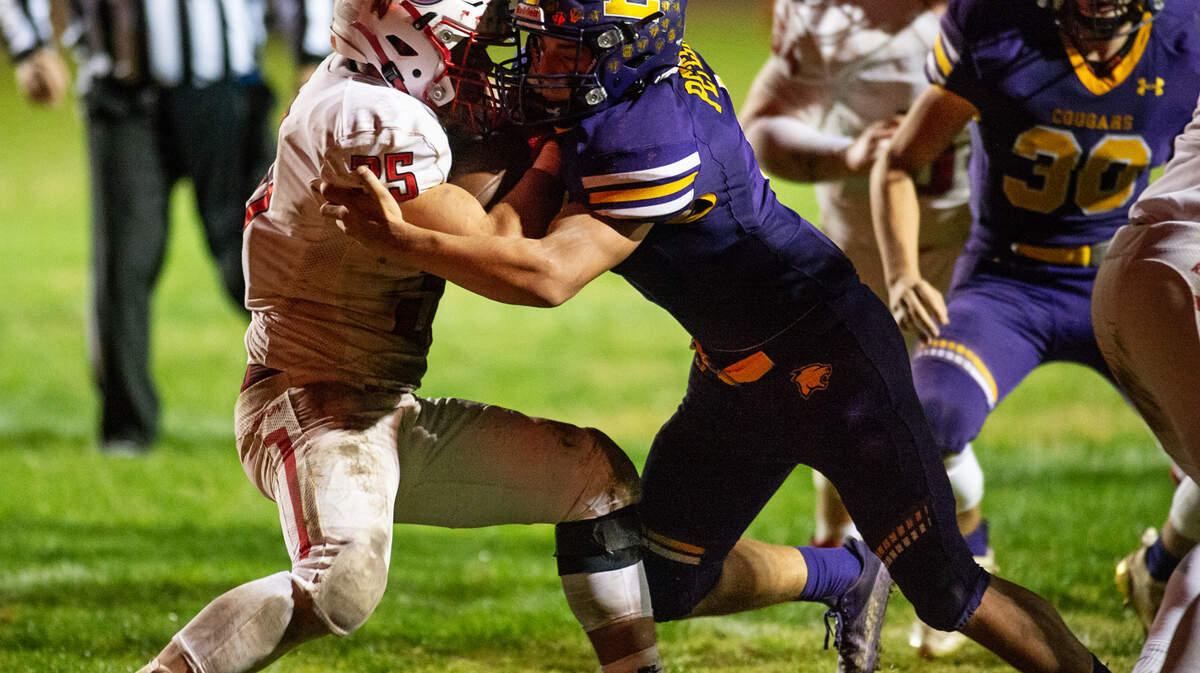 Escalon’s Ryker Peters stops Ripon runner Daniel Espinoza along the line of scrimmage during theTrans-Valley League game in Escalon, Calif., on Friday, Oct. 22, 2021. Escalon won the game 21-7.