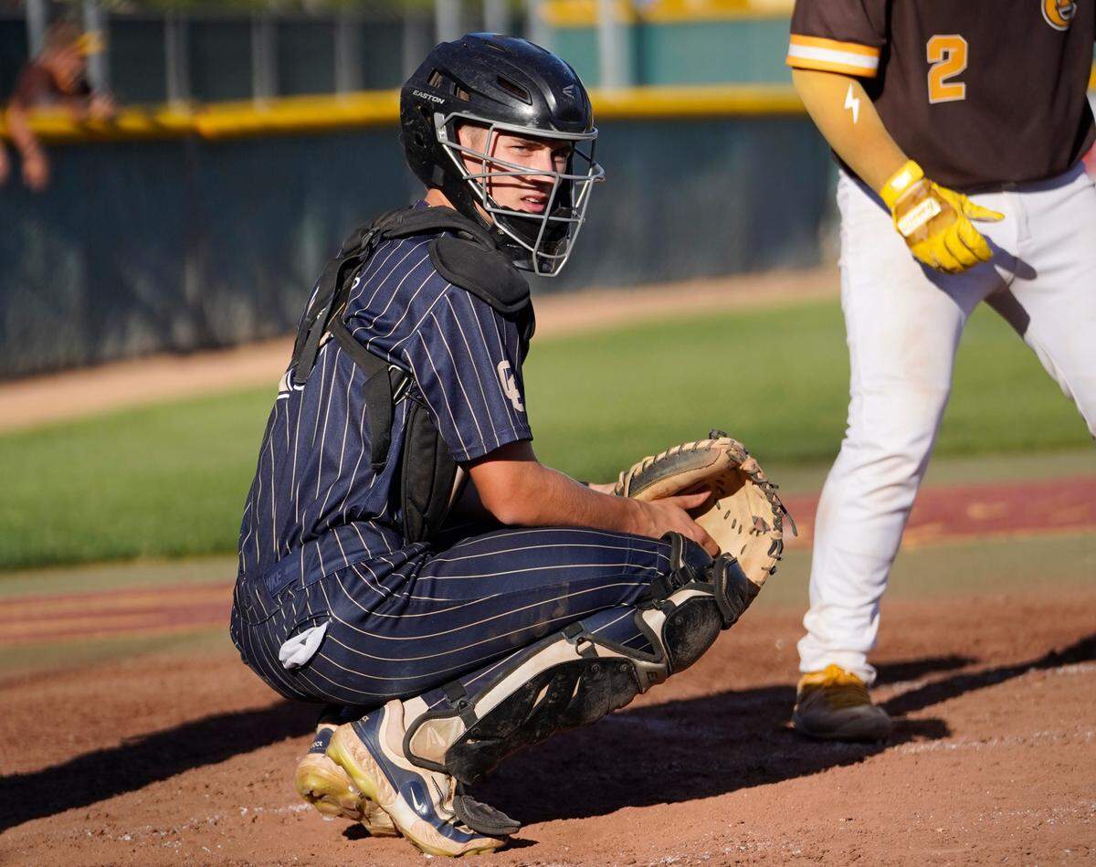 Central Catholic catcher Jacob Kiesel looks to the dugout for the pitch call during the Sac-Joaquin Section D-III championship game with Yuba City at Sacramento City College on Wednesday, May 21, 2025.